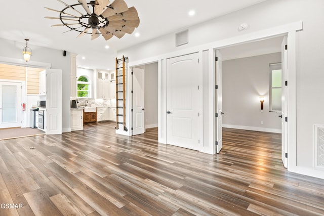 3955 Denton Ct, Sevierville, TN 37862 - unfurnished living room featuring wood finished floors, recessed lighting, and a barn door
