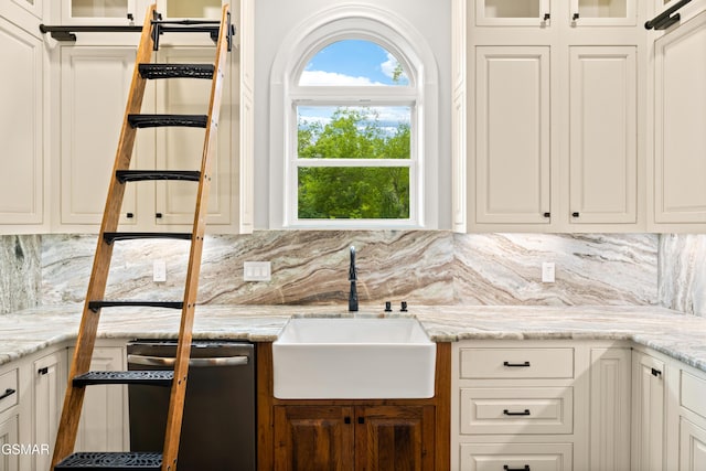 3955 Denton Ct, Sevierville, TN 37862 - kitchen featuring dishwashing machine, glass insert cabinets, tasteful backsplash, white cabinets, and light stone counters