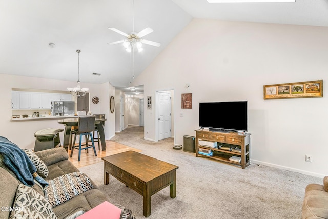 1218 Ernest Mcmahan Rd, Sevierville, TN 37862 - living area with high vaulted ceiling, a chandelier, ceiling fan, light carpet, and a skylight