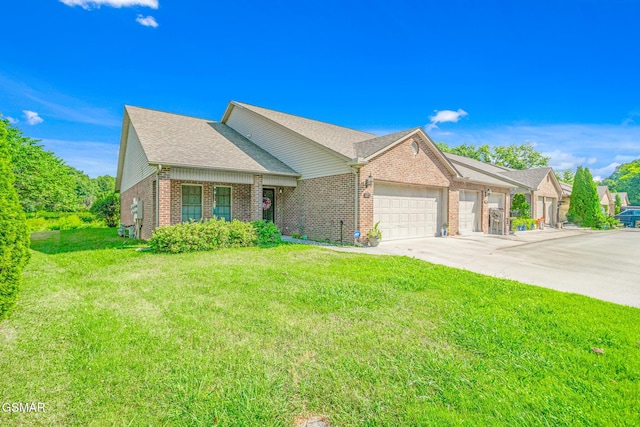 1218 Ernest Mcmahan Rd, Sevierville, TN 37862 - view of front of house featuring an attached garage, brick siding, concrete driveway, a front yard, and a shingled roof