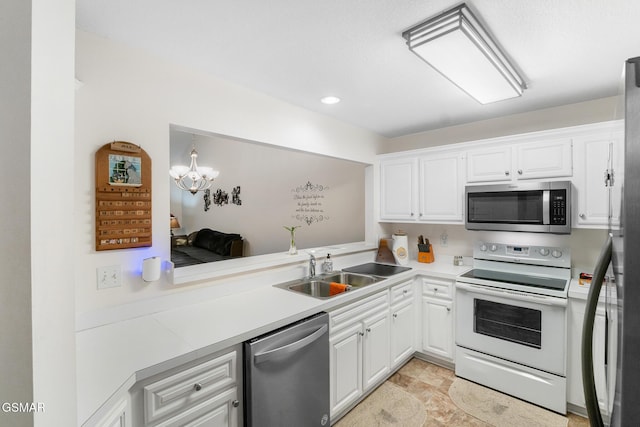 1218 Ernest Mcmahan Rd, Sevierville, TN 37862 - kitchen featuring stainless steel appliances, light countertops, white cabinets, a chandelier, and recessed lighting