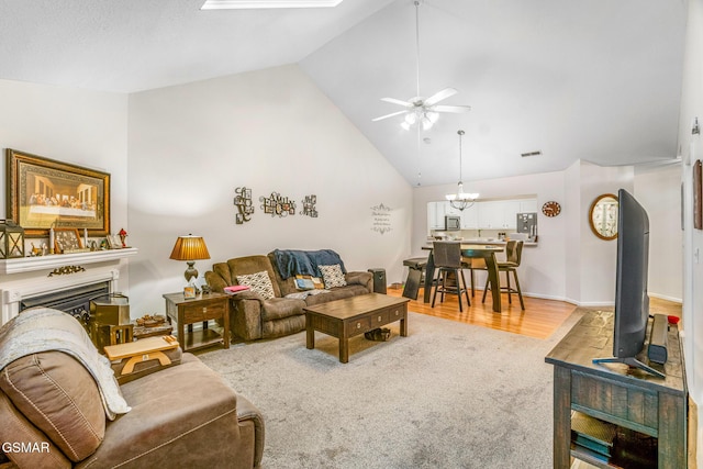 1218 Ernest Mcmahan Rd, Sevierville, TN 37862 - living room featuring ceiling fan, a chandelier, carpet flooring, a fireplace, and high vaulted ceiling