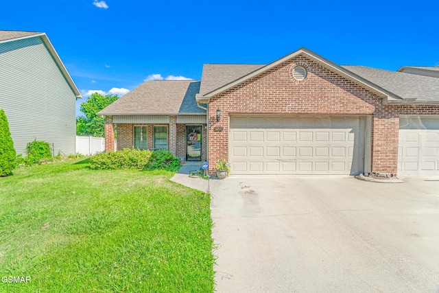 1218 Ernest Mcmahan Rd, Sevierville, TN 37862 - view of front of property featuring brick siding, roof with shingles, a garage, concrete driveway, and a front lawn