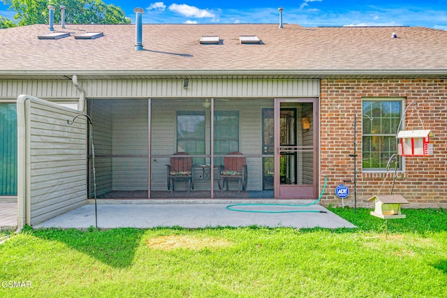 1218 Ernest Mcmahan Rd, Sevierville, TN 37862 - rear view of property with a sunroom, brick siding, roof with shingles, and a lawn