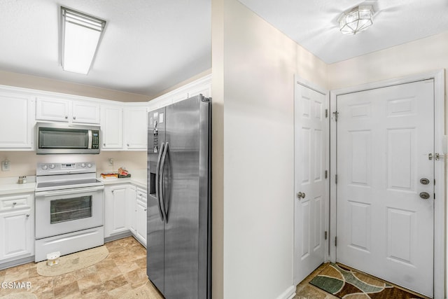 1218 Ernest Mcmahan Rd, Sevierville, TN 37862 - kitchen with stainless steel appliances, light countertops, white cabinetry, and stone finish flooring