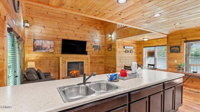 438 Alpine Mountain Way, Pigeon Forge, TN 37863 - kitchen with a glass covered fireplace, wood ceiling, a sink, wooden walls, and open floor plan