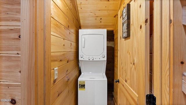 438 Alpine Mountain Way, Pigeon Forge, TN 37863 - washroom featuring wooden walls, laundry area, and stacked washer and clothes dryer