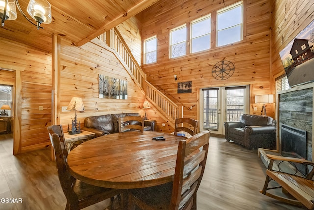692 Stockton Dr, Sevierville, TN 37876 - dining area featuring wooden walls, stairway, plenty of natural light, a fireplace, and wood finished floors