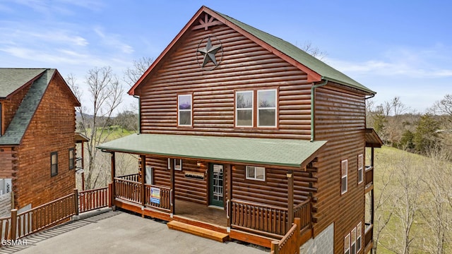 692 Stockton Dr, Sevierville, TN 37876 - rear view of property featuring a porch, a shingled roof, and log siding