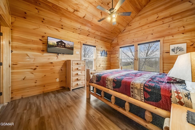 692 Stockton Dr, Sevierville, TN 37876 - bedroom with vaulted ceiling, wood finished floors, wood walls, a ceiling fan, and wooden ceiling