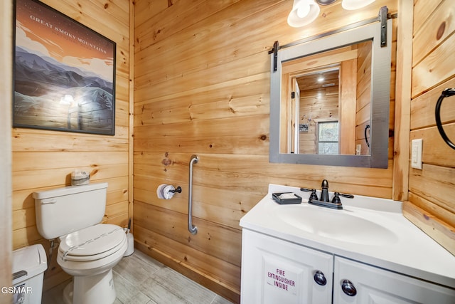 692 Stockton Dr, Sevierville, TN 37876 - bathroom with wood walls, toilet, and vanity