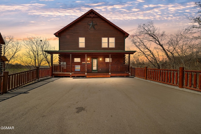 692 Stockton Dr, Sevierville, TN 37876 - cabin featuring log siding, covered porch, and driveway