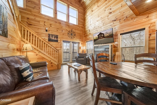 692 Stockton Dr, Sevierville, TN 37876 - living room featuring a towering ceiling, wooden walls, plenty of natural light, a fireplace, and wood finished floors