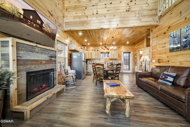692 Stockton Dr, Sevierville, TN 37876 - living area featuring wood walls, dark wood finished floors, a stone fireplace, wood ceiling, and recessed lighting