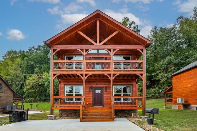 cabin featuring a front lawn