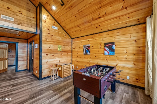 game room featuring dark hardwood / wood-style flooring, vaulted ceiling, wooden walls, and wood ceiling