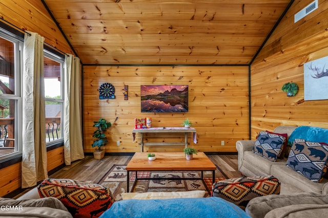 living room with wooden walls, wood-type flooring, lofted ceiling, and wooden ceiling