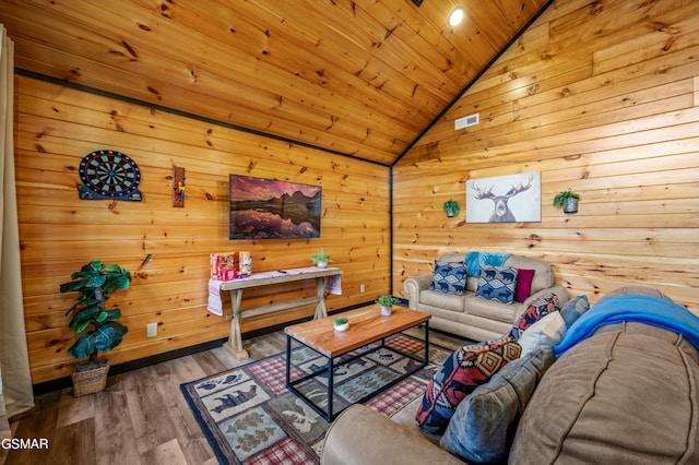 living room featuring wooden walls, hardwood / wood-style floors, wood ceiling, and vaulted ceiling