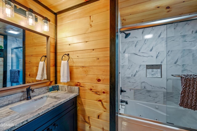 bathroom with vanity, combined bath / shower with glass door, wooden ceiling, and wooden walls