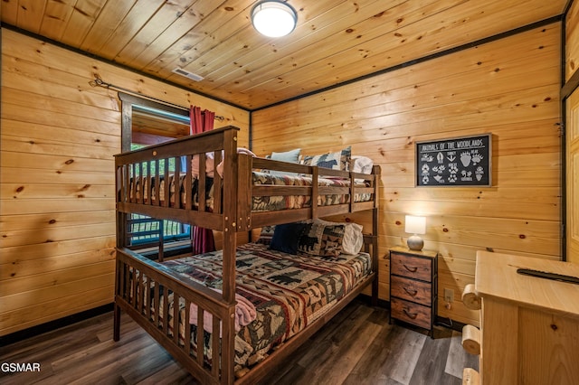 bedroom with wood walls, dark hardwood / wood-style flooring, and wooden ceiling