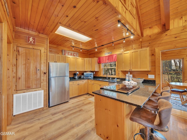 kitchen featuring a sink, stainless steel appliances, rail lighting, a peninsula, and visible vents