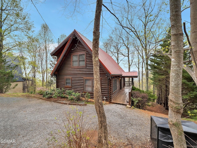 view of side of property featuring metal roof