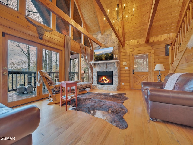 living area featuring wood ceiling, plenty of natural light, hardwood / wood-style flooring, and a fireplace