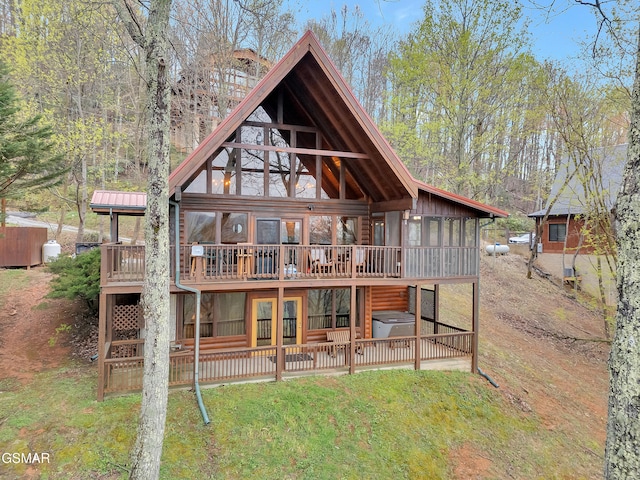 rear view of house with a patio, a yard, and a deck