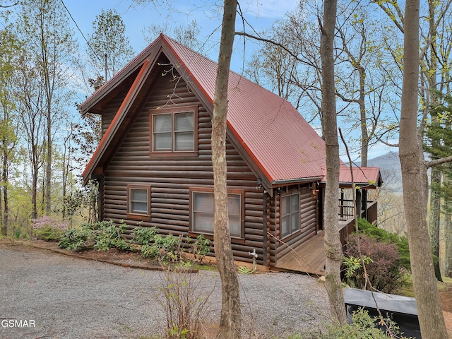 view of front of home with log exterior and metal roof