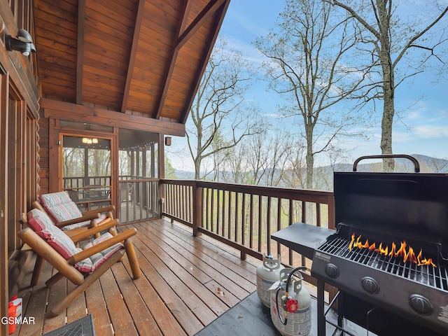 wooden deck with a grill