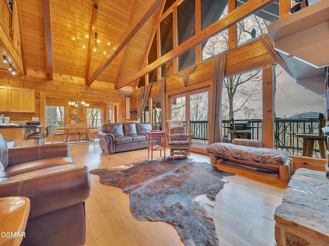 living area with high vaulted ceiling, hardwood / wood-style flooring, a chandelier, wood ceiling, and beam ceiling