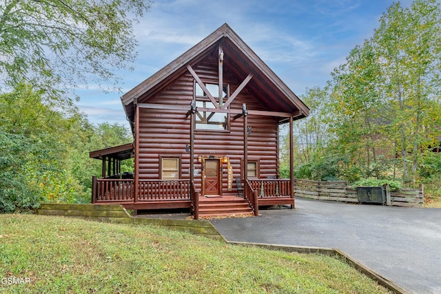 cabin featuring a front yard and a patio area