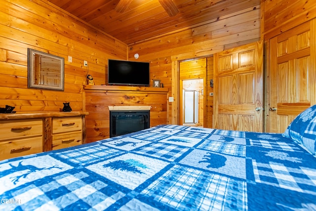 bedroom featuring wooden walls and wood ceiling