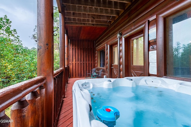 wooden terrace with a hot tub