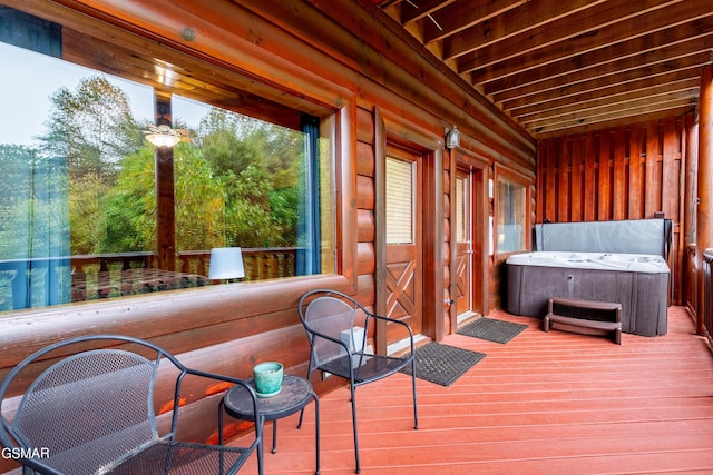 wooden terrace featuring a hot tub