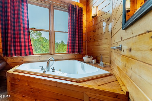 bathroom featuring wooden walls and a washtub