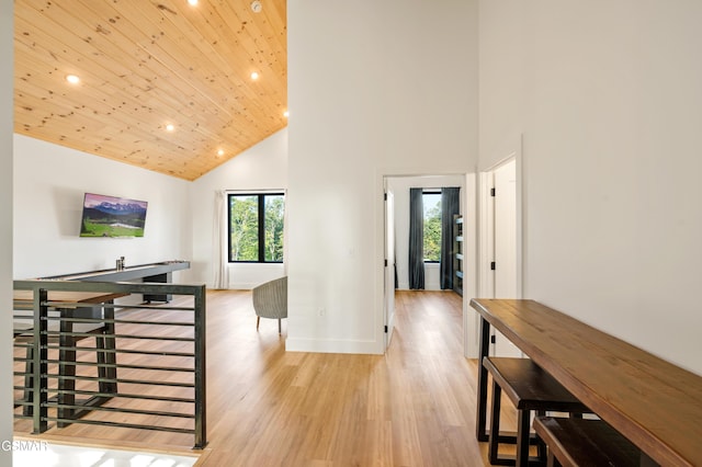 corridor with high vaulted ceiling, recessed lighting, light wood-style floors, baseboards, and wood ceiling