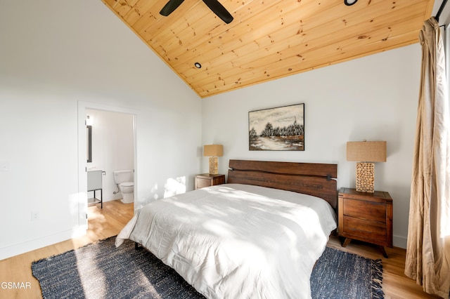 bedroom with wood finished floors, lofted ceiling, wooden ceiling, baseboards, and ensuite bath