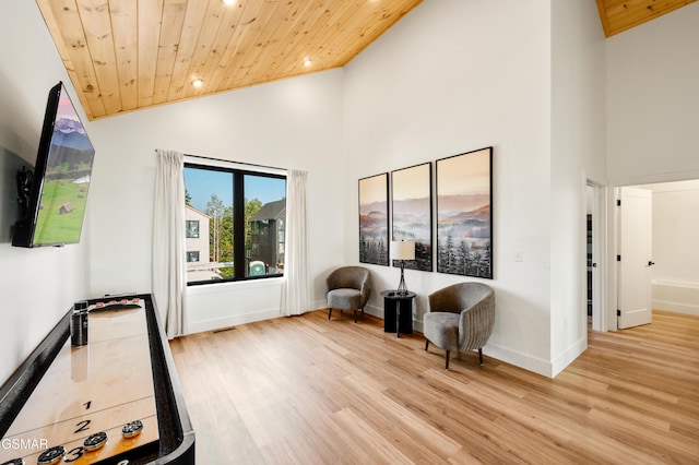 sitting room with wood ceiling, wood finished floors, high vaulted ceiling, recessed lighting, and baseboards