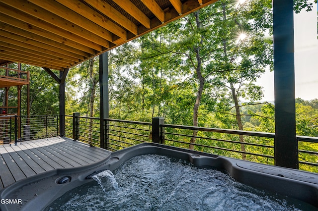 wooden deck with view of scattered trees