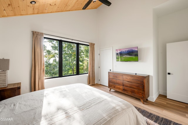 bedroom featuring wooden ceiling, light wood finished floors, high vaulted ceiling, and ceiling fan