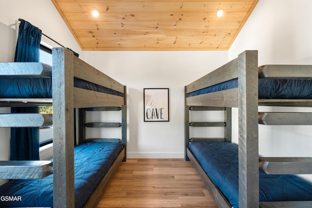bedroom with wood finished floors, lofted ceiling, wooden ceiling, baseboards, and recessed lighting
