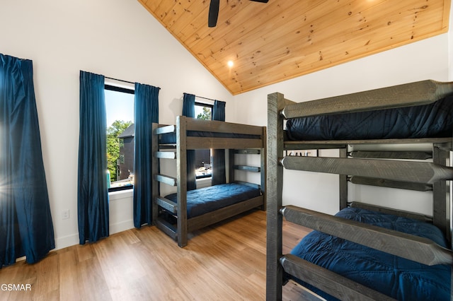 bedroom featuring wood finished floors, wood ceiling, vaulted ceiling, and baseboards