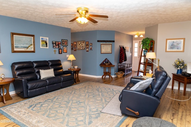 living room with a textured ceiling, hardwood / wood-style floors, and ceiling fan