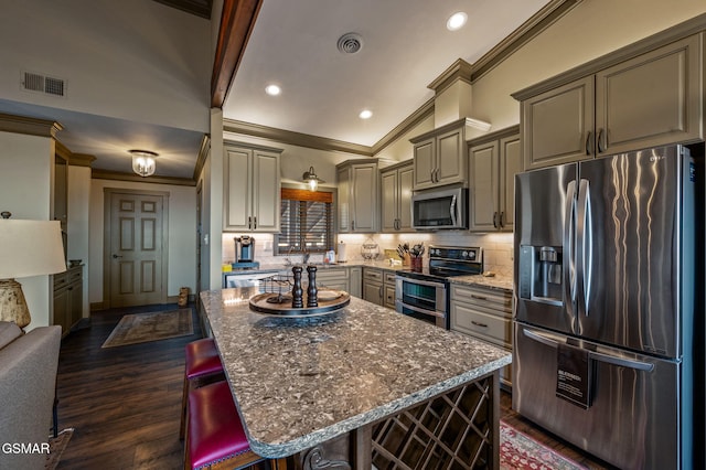 1050 Ski View Dr Unit 306, Gatlinburg, TN 37738 - kitchen featuring appliances with stainless steel finishes, ornamental molding, tasteful backsplash, dark stone counters, and recessed lighting