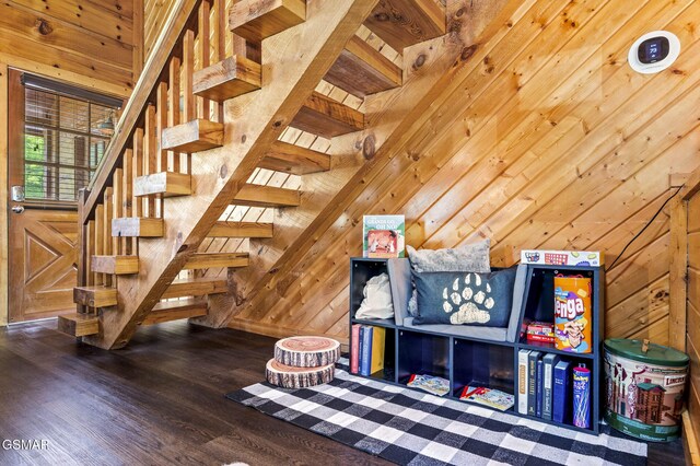 playroom with hardwood / wood-style flooring and wood walls