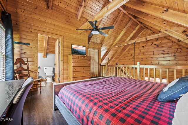 bedroom featuring beam ceiling, ensuite bath, ceiling fan, wood walls, and wood ceiling