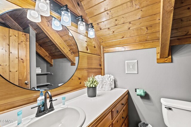 bathroom featuring lofted ceiling with beams, vanity, wood ceiling, and toilet