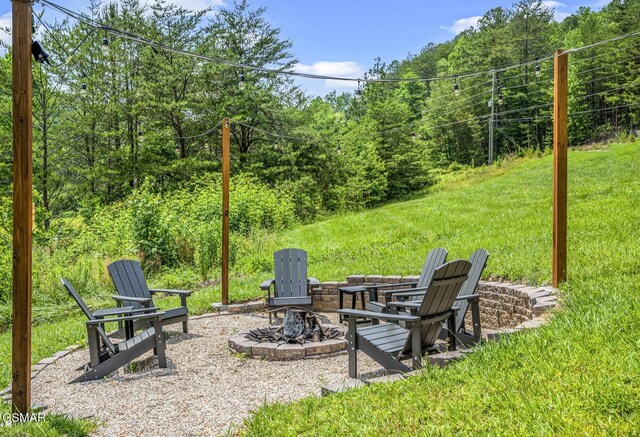 view of yard with a fire pit