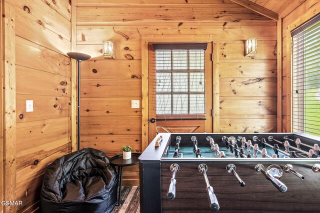 rec room with wood walls, wood ceiling, and lofted ceiling